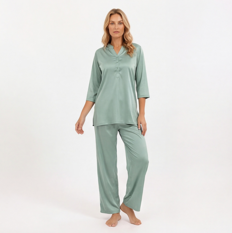 Woman wearing a green pajama set on a white background
