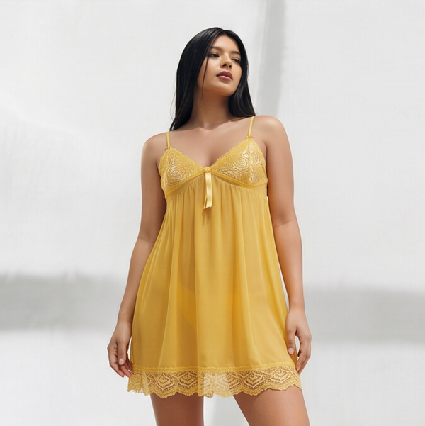 Woman wearing a yellow lace nightgown against a white background