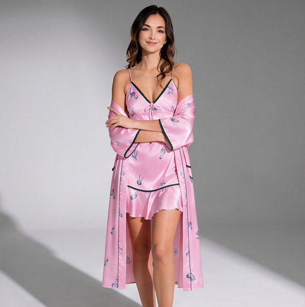 Woman wearing a pink satin robe with floral patterns on a gray background